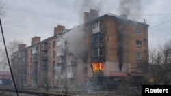 Smoke rises from a building damaged by a Russian military strike, amid their attack on Ukraine, in the front line city of Bakhmut, in Donetsk region, Ukraine, Feb. 27, 2023.