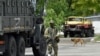 FILE - A Russian serviceman patrols a street in Kherson, amid Russia's ongoing invasion of Ukraine. May 20, 2022.