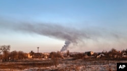 Smoke rises after shelling in Soledar, the site of heavy battles with Russian forces in the Donetsk region, Ukraine, Jan. 8, 2023. 