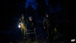 Elderly residents are evacuated from the southern city of Kherson, Ukraine, Nov. 27, 2022.