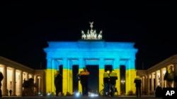 The Brandenburg Gate in Berlin, Germany, is illuminated in the colors of the Ukrainian flag to show solidarity with the country as Russia launches a military operation, Feb. 23, 2022.