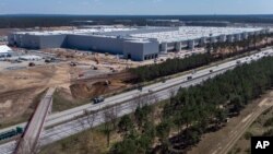 The construction site of the new Tesla Gigafactory for electric cars is pictured in Gruenheide near Berlin, Germany, Tuesday, April 27, 2021. Factories in Berlin and Austin, Texas, are on track to start producing this year. (AP Photo/Michael Sohn)